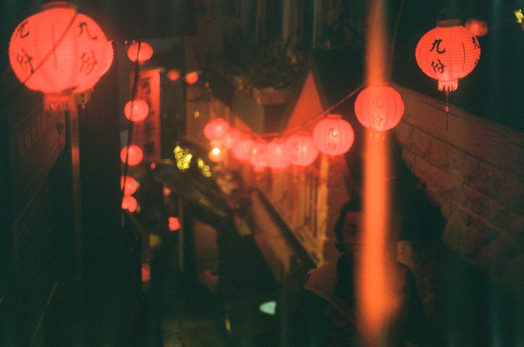 Image is a grainy film shot in Jioufen, with an emphasis on the red lanterns.