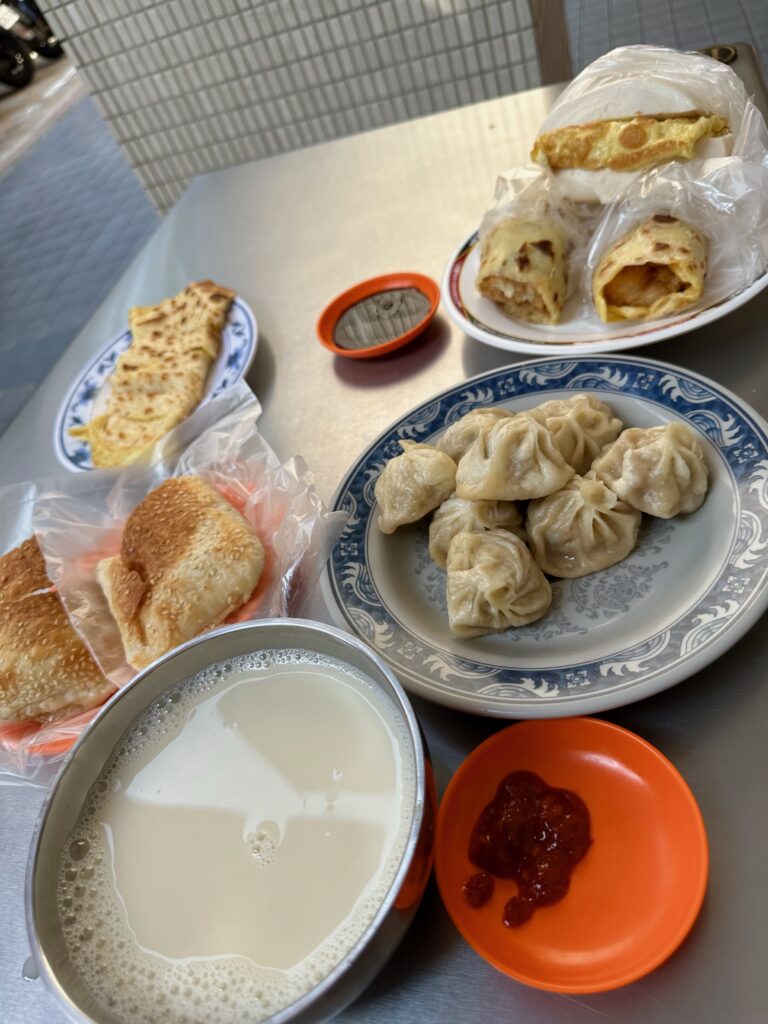 Image shows picture of hot soymilk, xiaolong baos, and crispy egg omelettes.